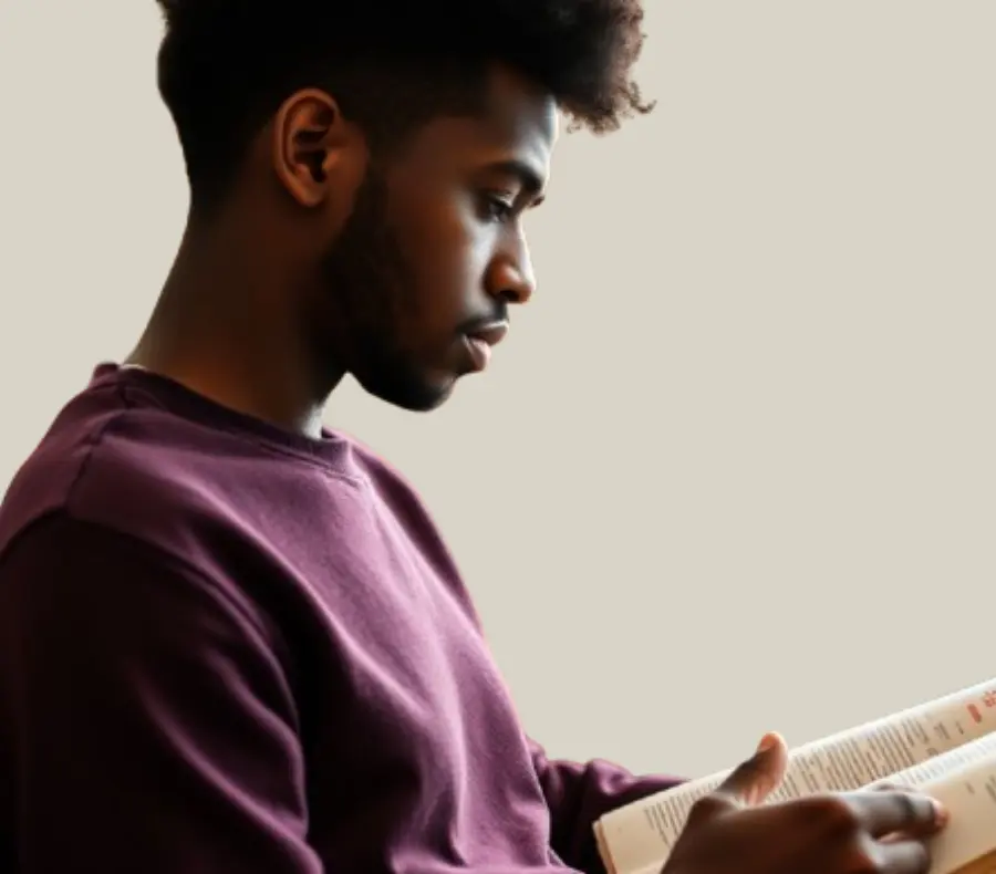 A young man studying a book